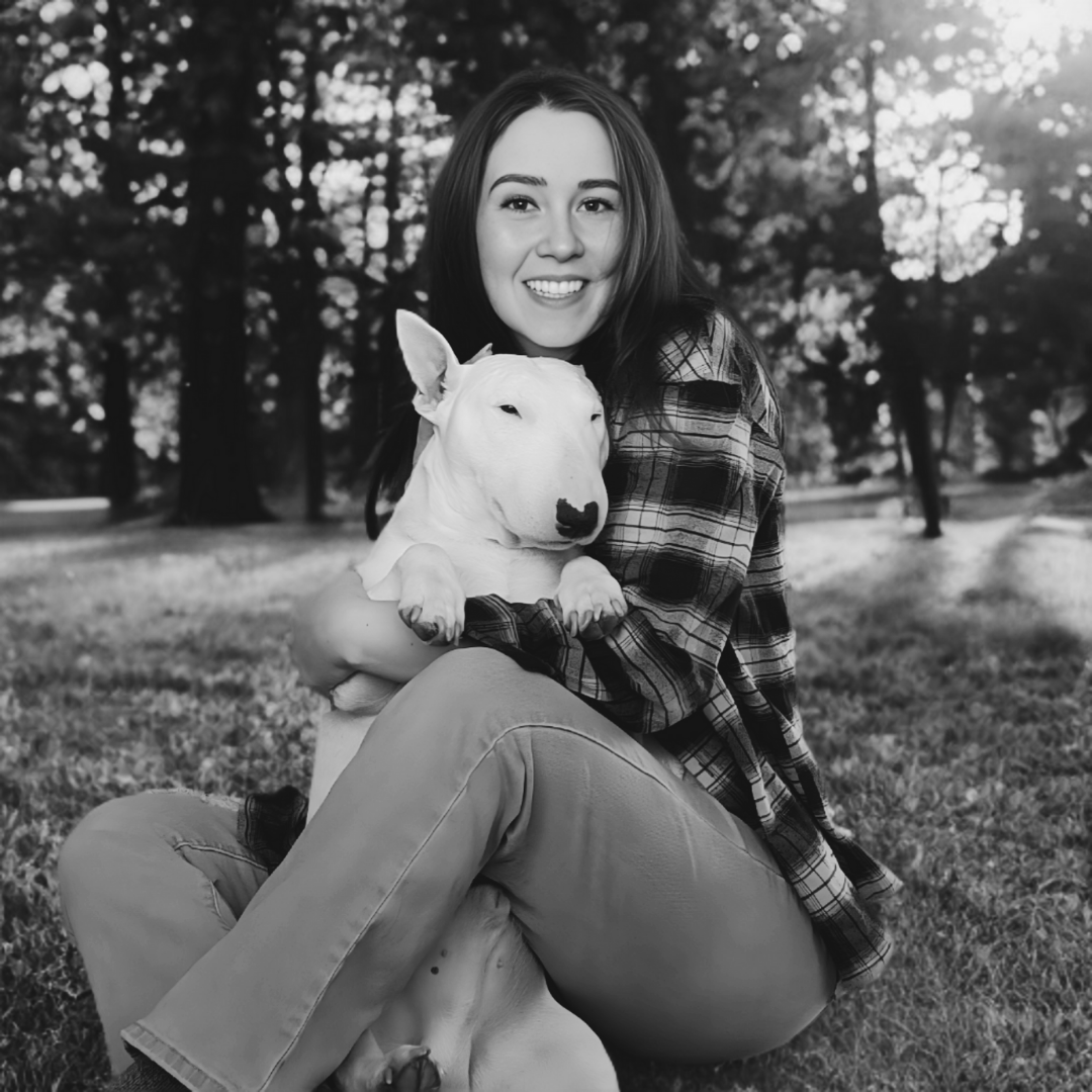 Woman holding a dog in a park