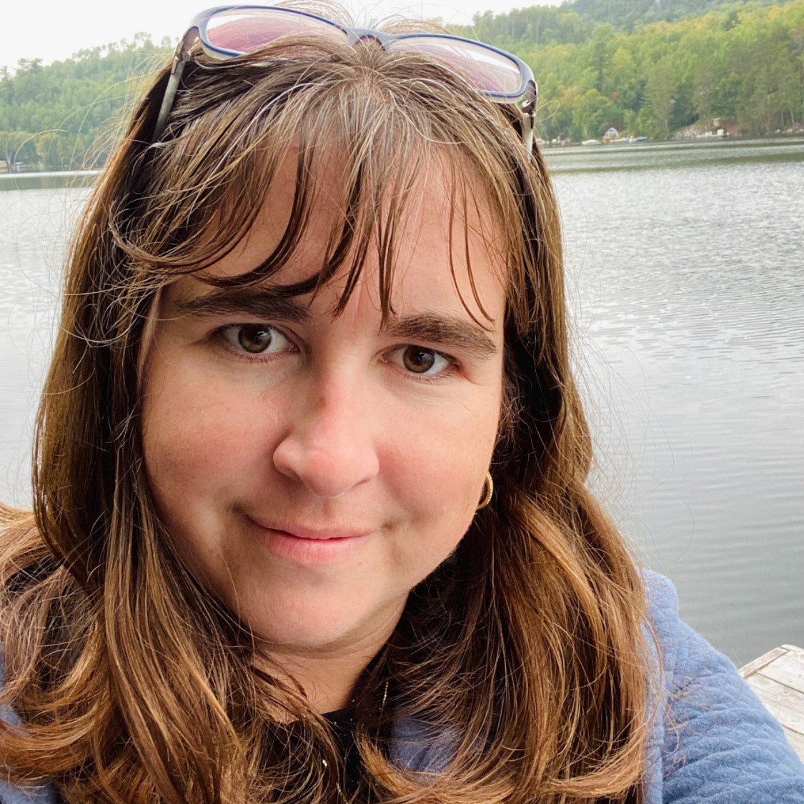 Woman, Athena Barnim, with sunglasses on head by a lake
